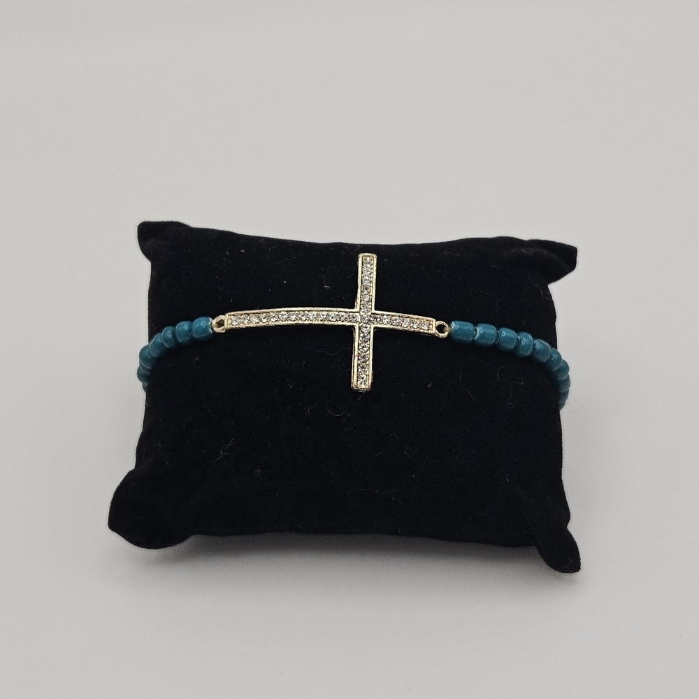 teal beaded stretch bracelet with rhinestone cross charm